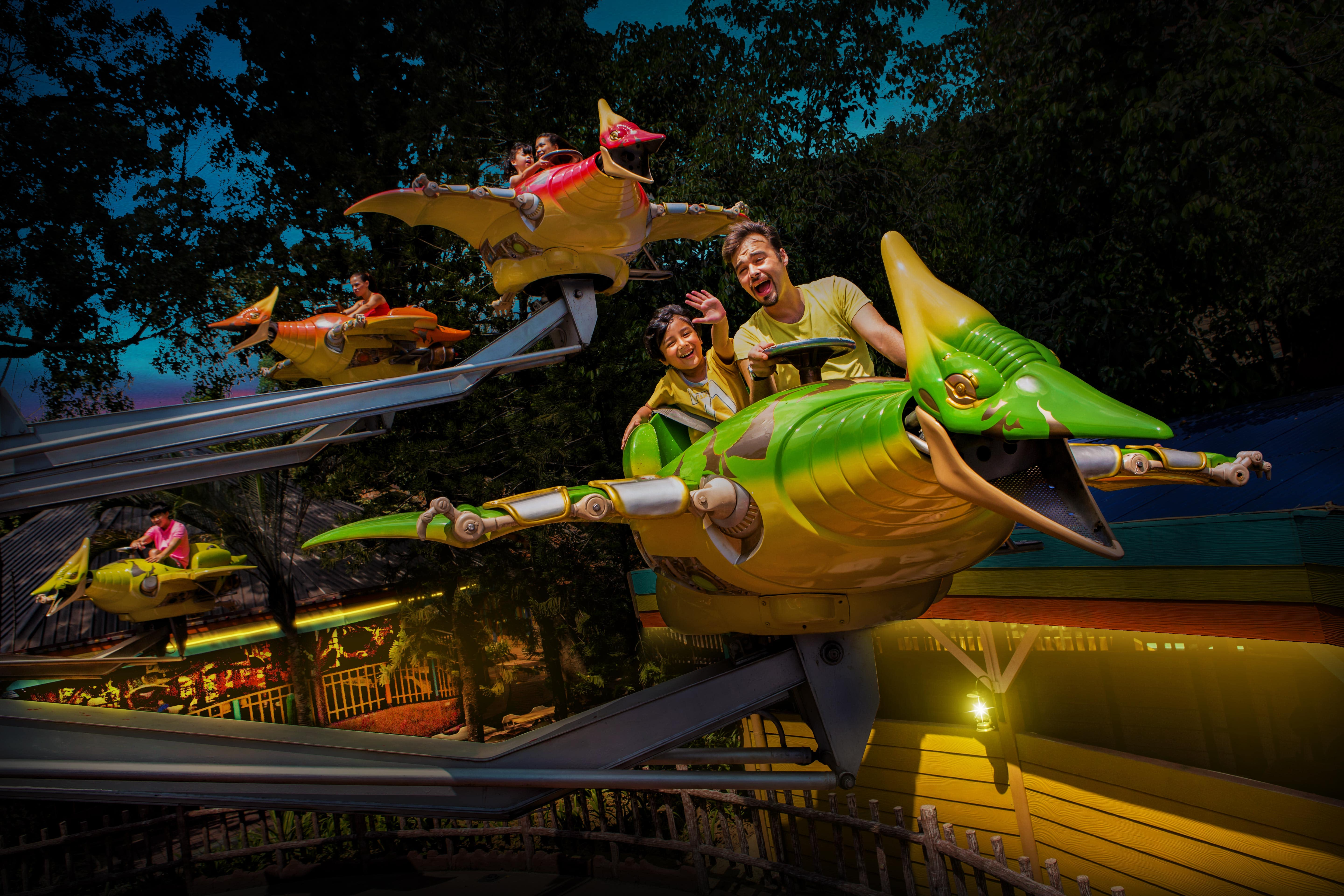 Sunway Lagoon water park slide with people enjoying the ride in Malaysia.