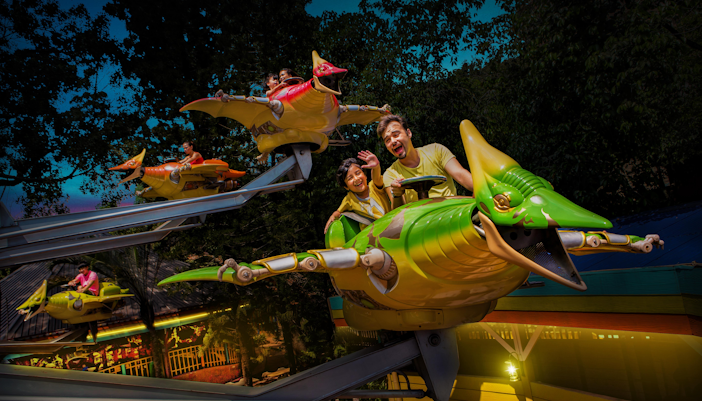 Sunway Lagoon water park slide with people enjoying the ride in Malaysia.