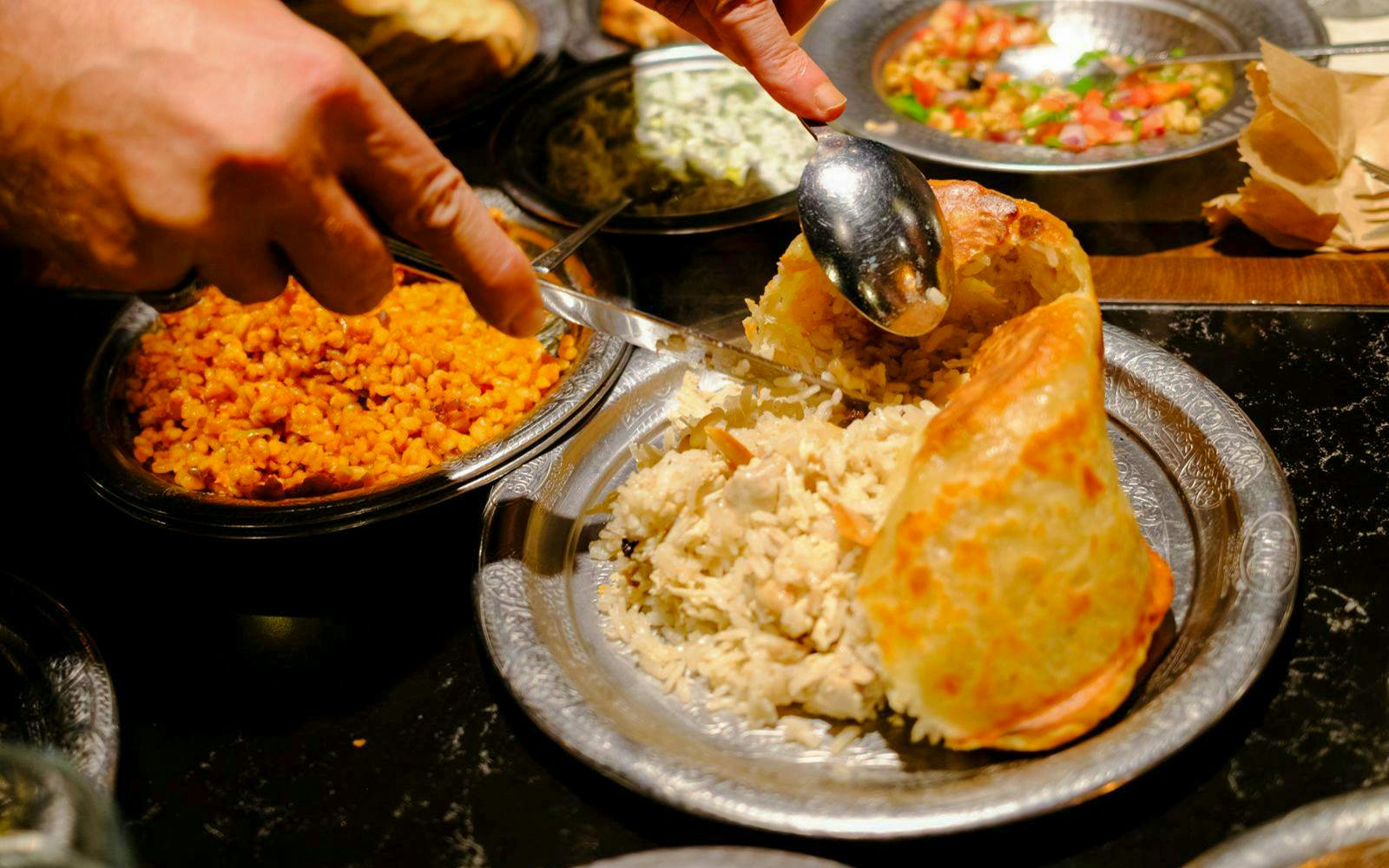 Traditional Turkish rice and bulgur dishes being served at a food night in Istanbul.