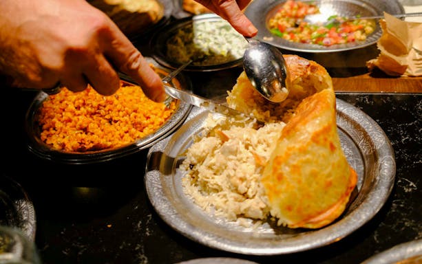 Traditional Turkish rice and bulgur dishes being served at a food night in Istanbul.