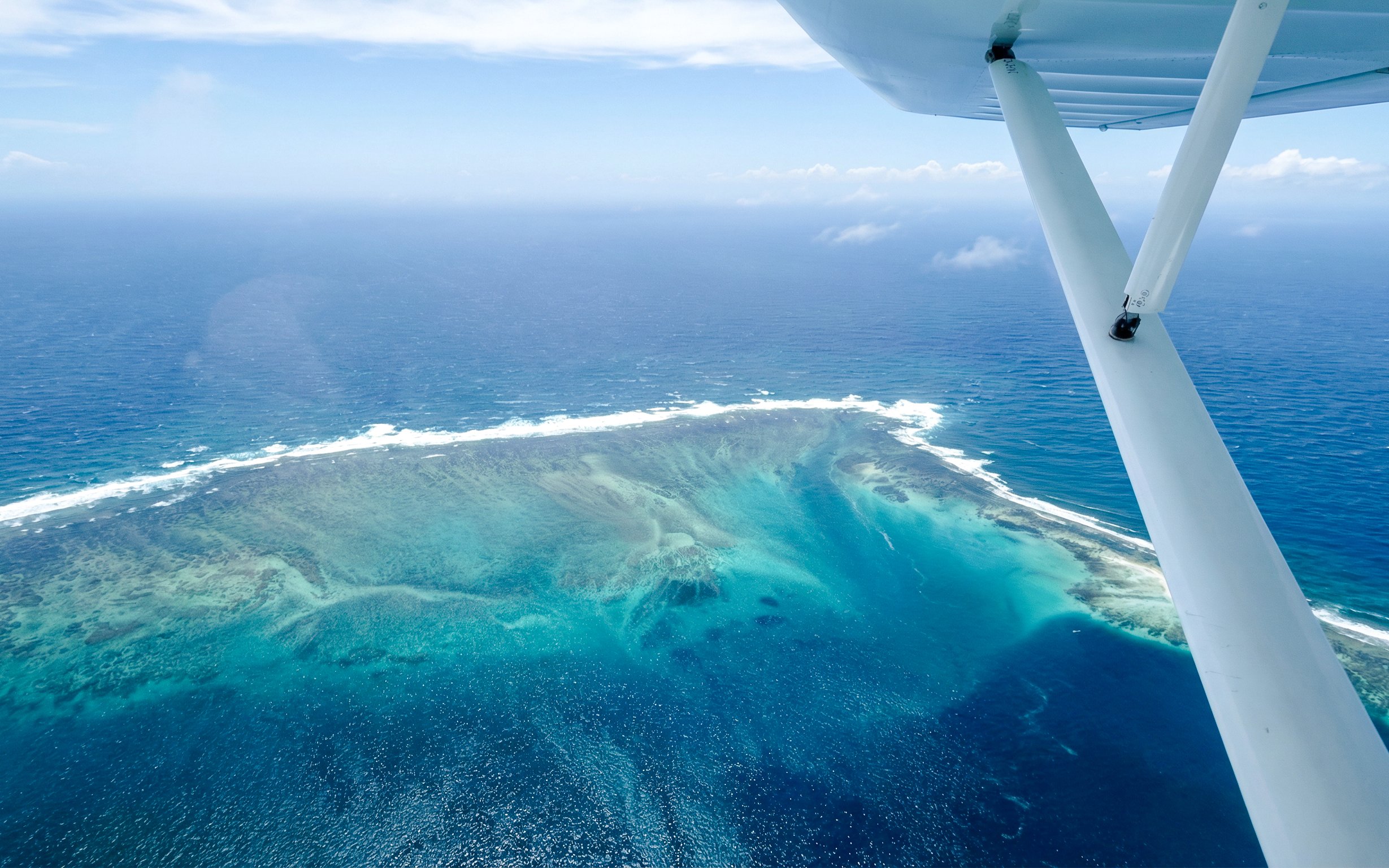 Seaplane view of the underwater waterfall illusion off Mauritius coast.