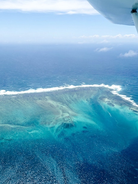Seaplane view of the underwater waterfall illusion off Mauritius coast.