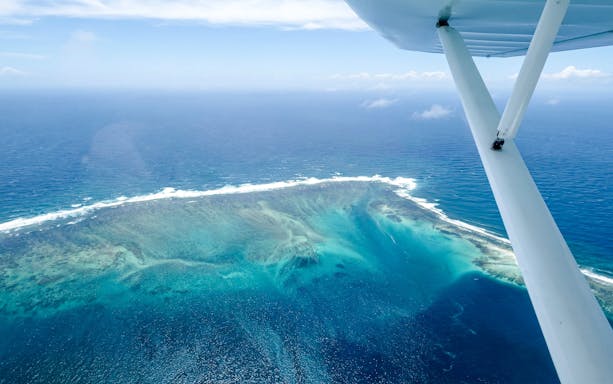 Seaplane view of the underwater waterfall illusion off Mauritius coast.