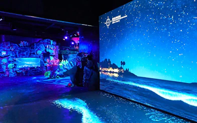 SEA LIFE Aquarium Busan exhibit with illuminated coral and ocean projection.