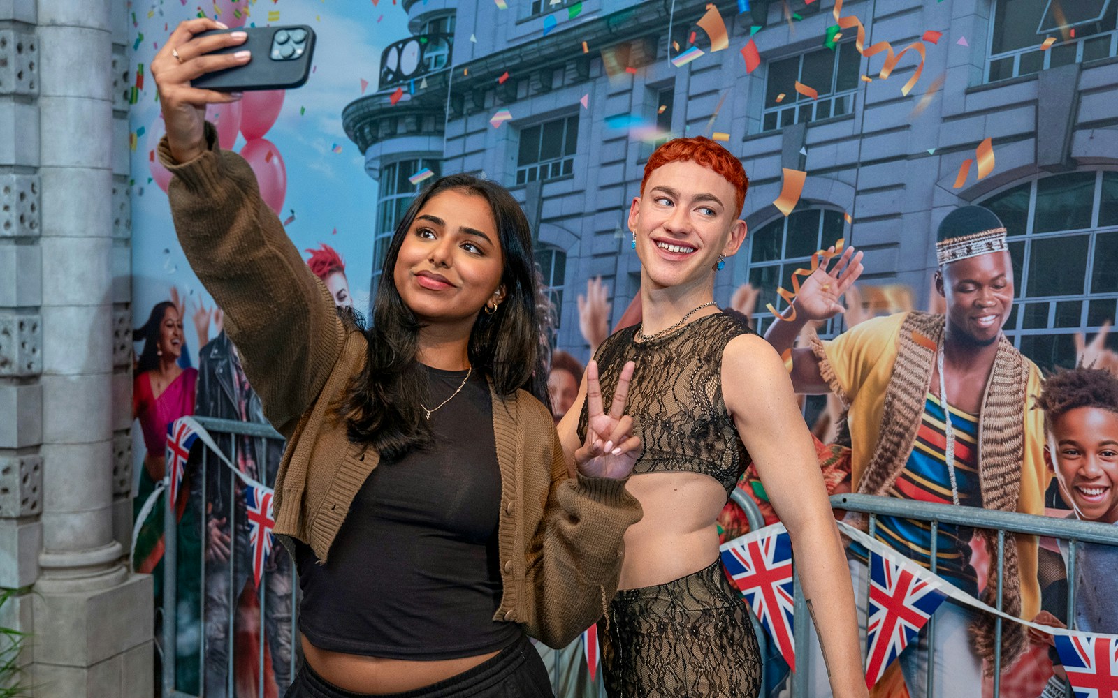 Visitors taking a selfie with wax figures at Madame Tussauds London.