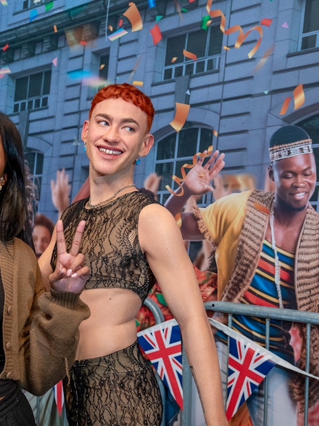 Visitors taking a selfie with wax figures at Madame Tussauds London.