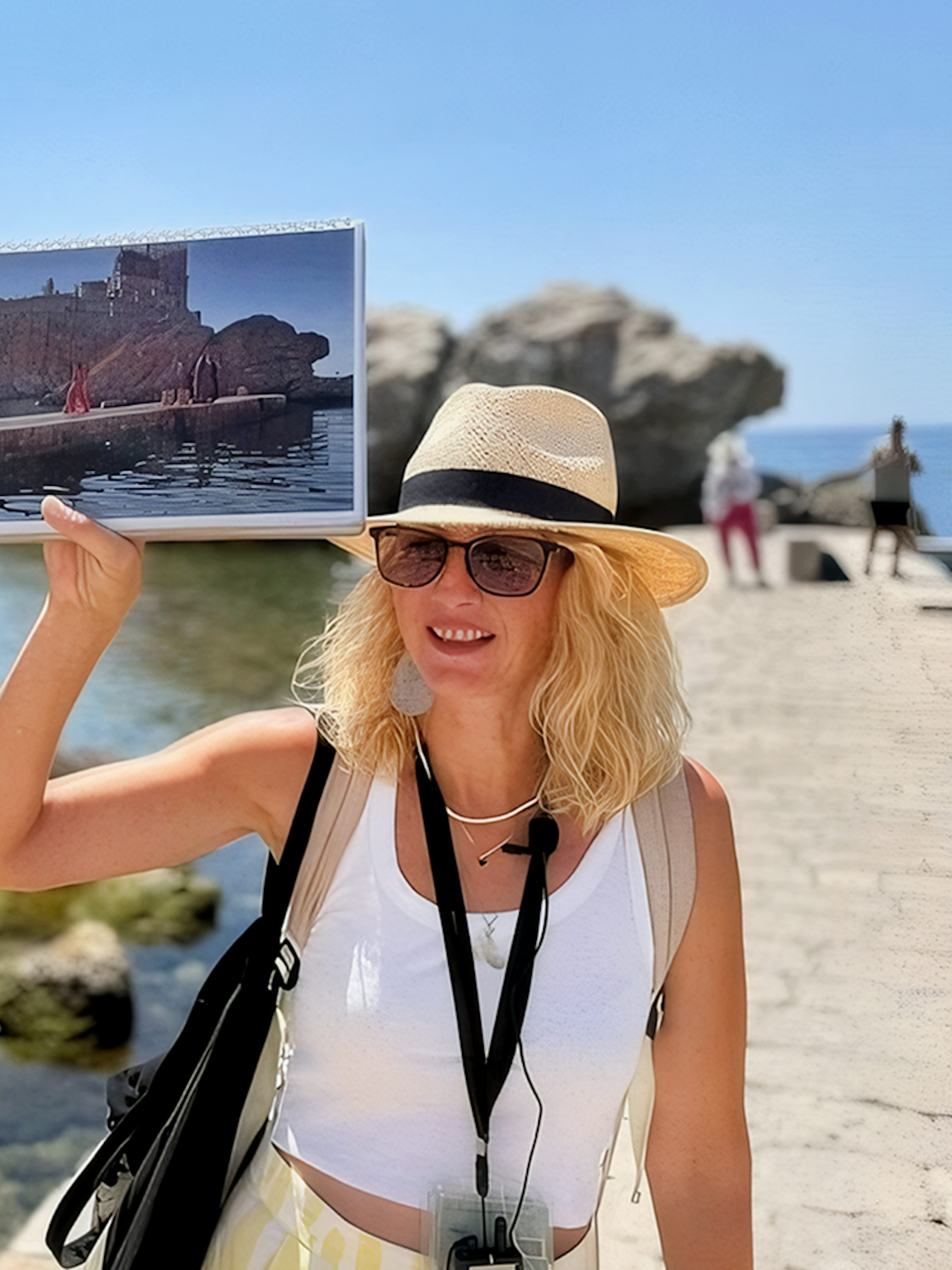 Female guide showing Game of Thrones location to tourists in Dubrovnik, Croatia.