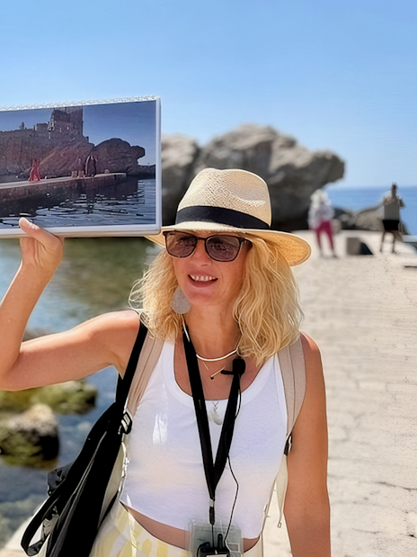 Female guide showing Game of Thrones location to tourists in Dubrovnik, Croatia.
