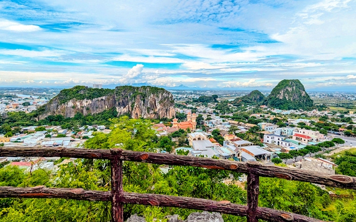Marble Mountains view over Da Nang cityscape with lush greenery and rocky peaks.