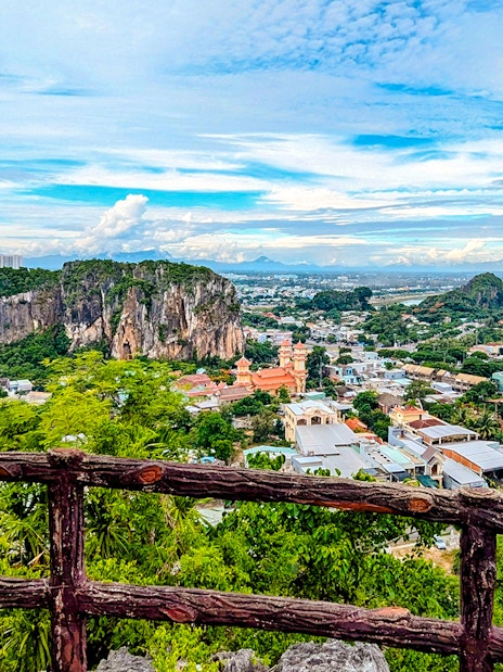 Marble Mountains view over Da Nang cityscape with lush greenery and rocky peaks.