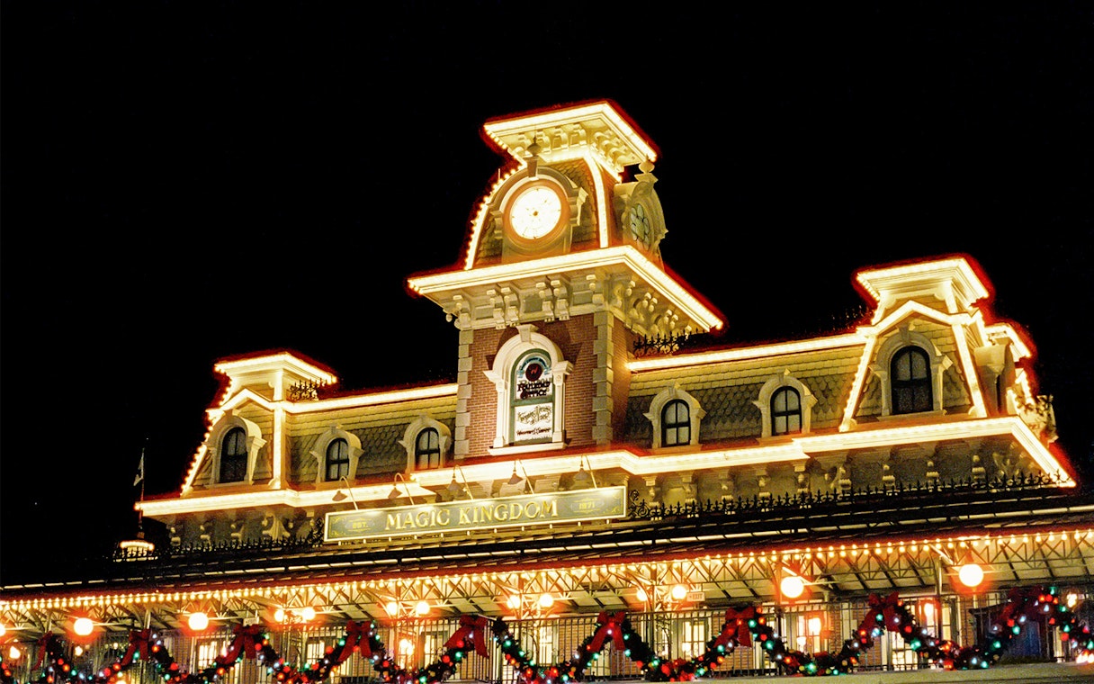 Magic Kingdom entrance adorned with Christmas lights at Walt Disney World Orlando.