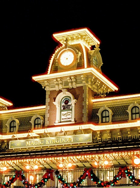 Magic Kingdom entrance adorned with Christmas lights at Walt Disney World Orlando.
