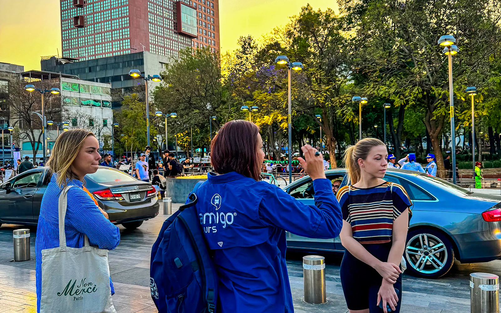 Tour guide leading a group in a city square during a guided night tour.