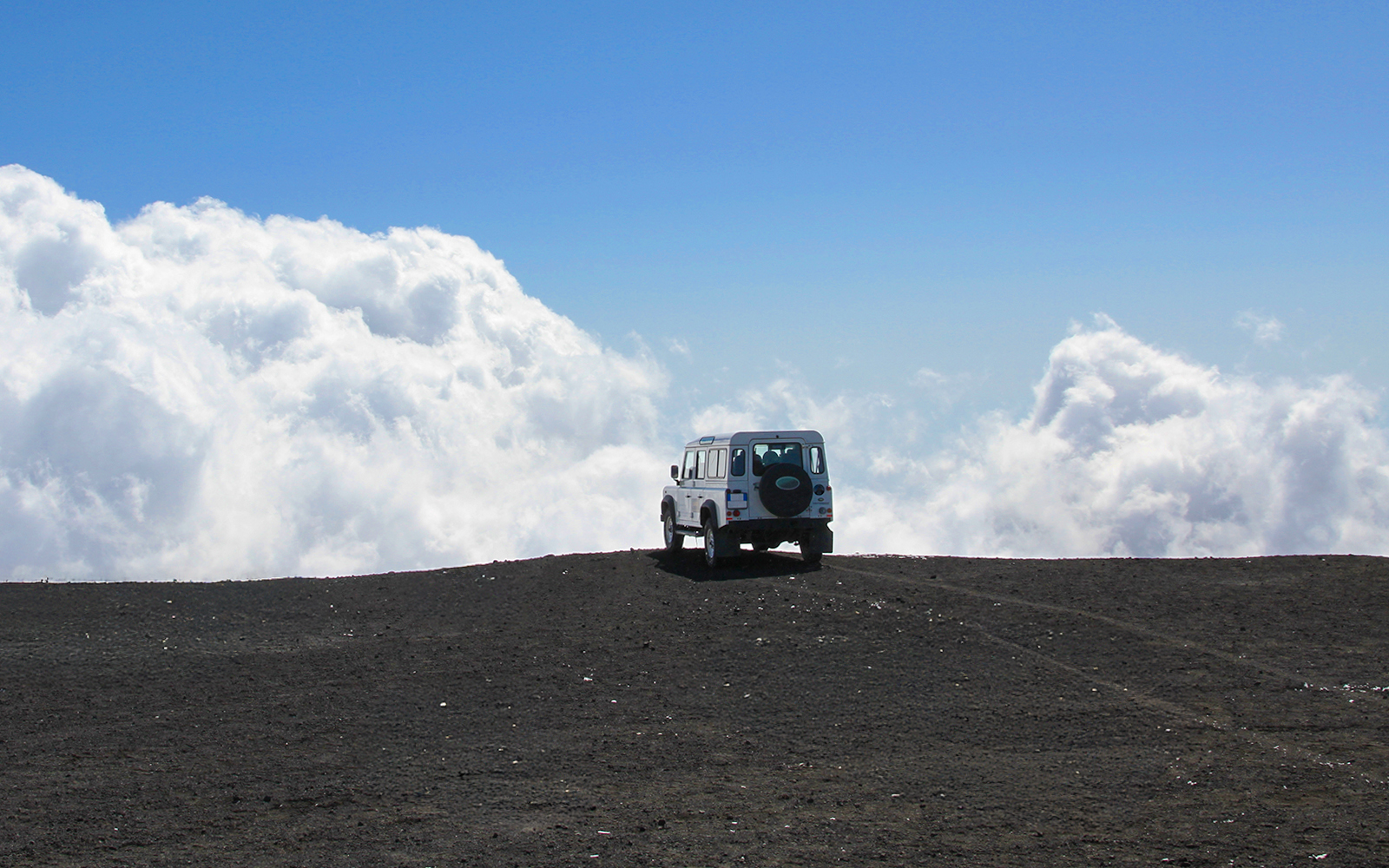Jeep navigating rugged terrain on Mount Etna during guided tour in Catania, Sicily.