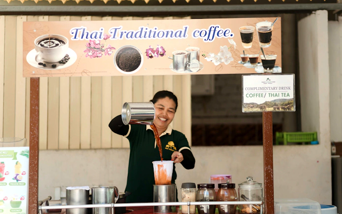 Barista preparing traditional Thai coffee at Bukit Elephant Park.