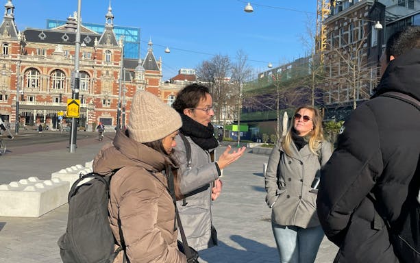 Tour guide explaining outside Anne Frank House in Amsterdam.