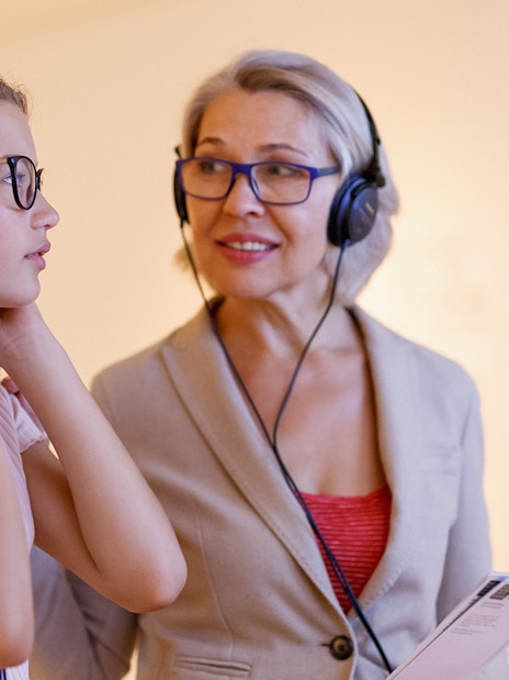 Tourists using audio guides in a museum setting.