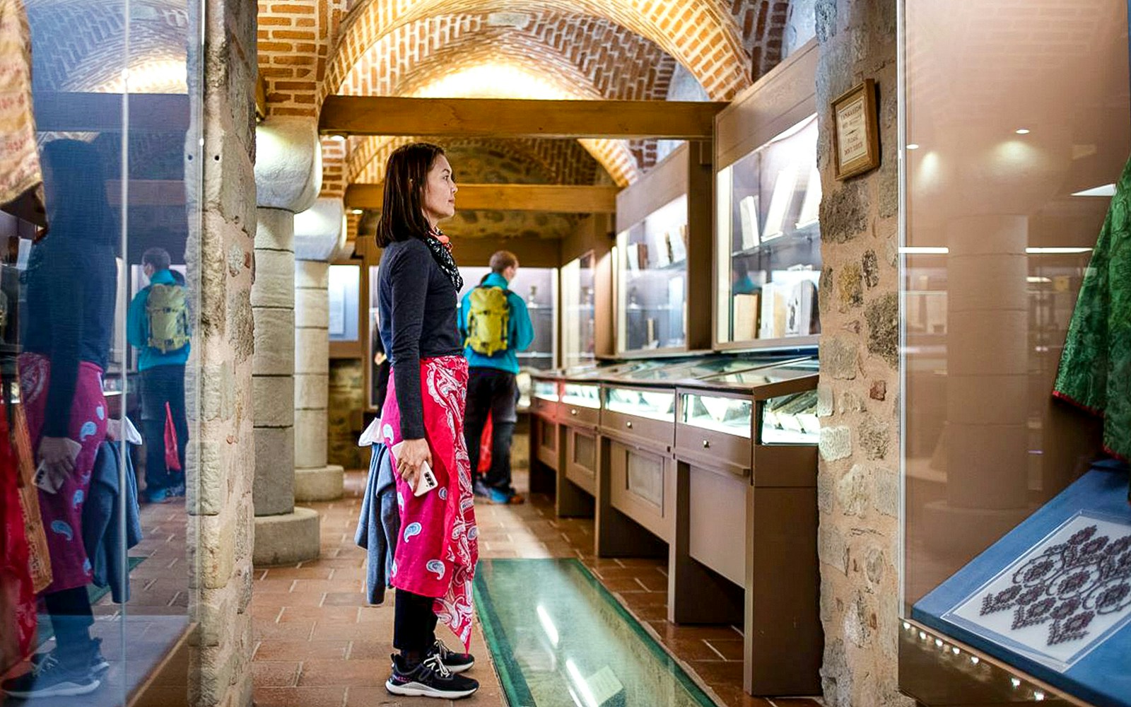 Female guest viewing exhibits inside Meteora Monastery, Greece.