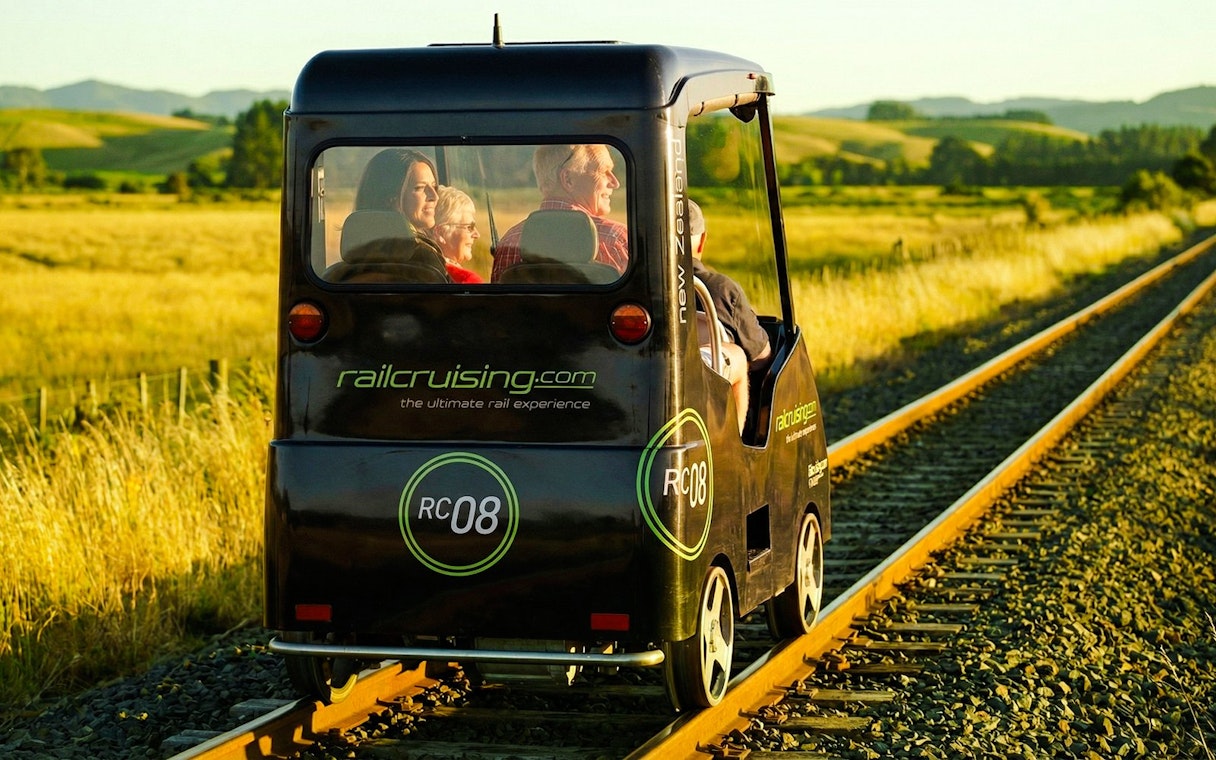 Self-drive rail car on tracks through Ngongotaha countryside, New Zealand.