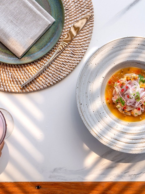 Seafood dish and cocktail at Yona Beach Club, Phuket.