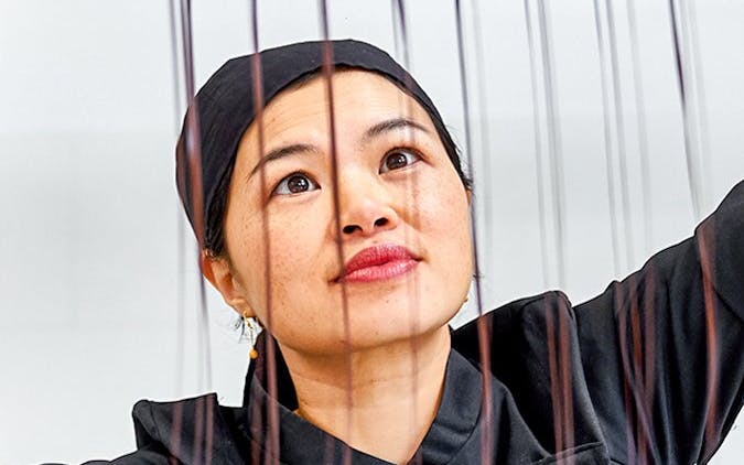 Chocolatier pouring chocolate into molds at Choco Story Brussels.