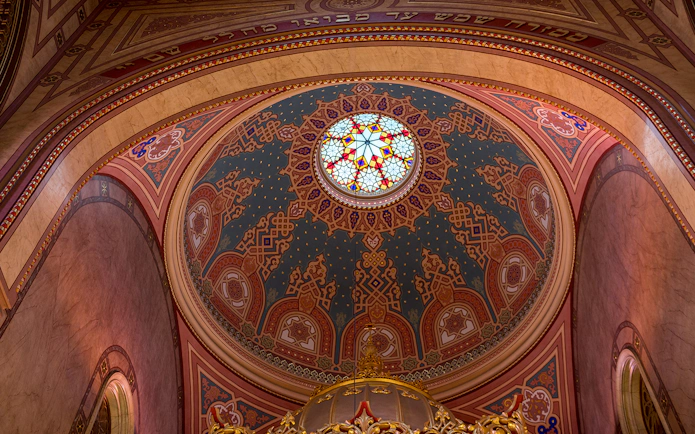 Stained glass dome interior of the Great Synagogue, intricate patterns and vibrant colors.