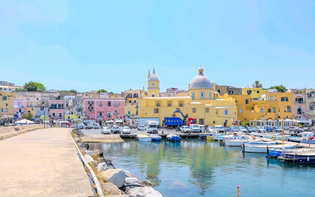 Colorful buildings and boats at the harbor of Procida Island, Italy.