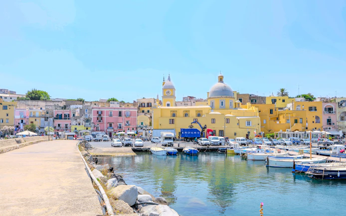 Colorful buildings and boats at the harbor of Procida Island, Italy.