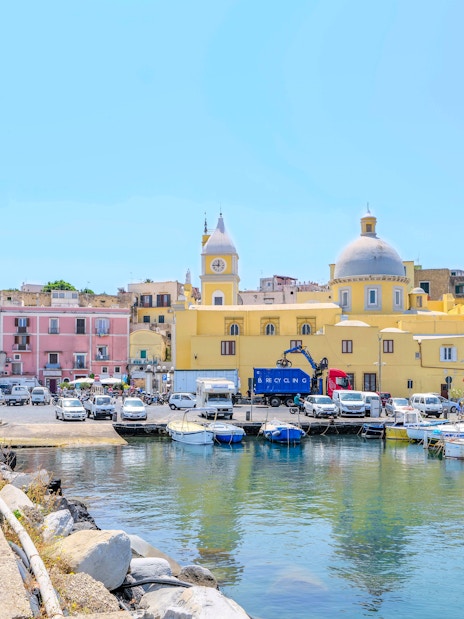 Colorful buildings and boats at the harbor of Procida Island, Italy.