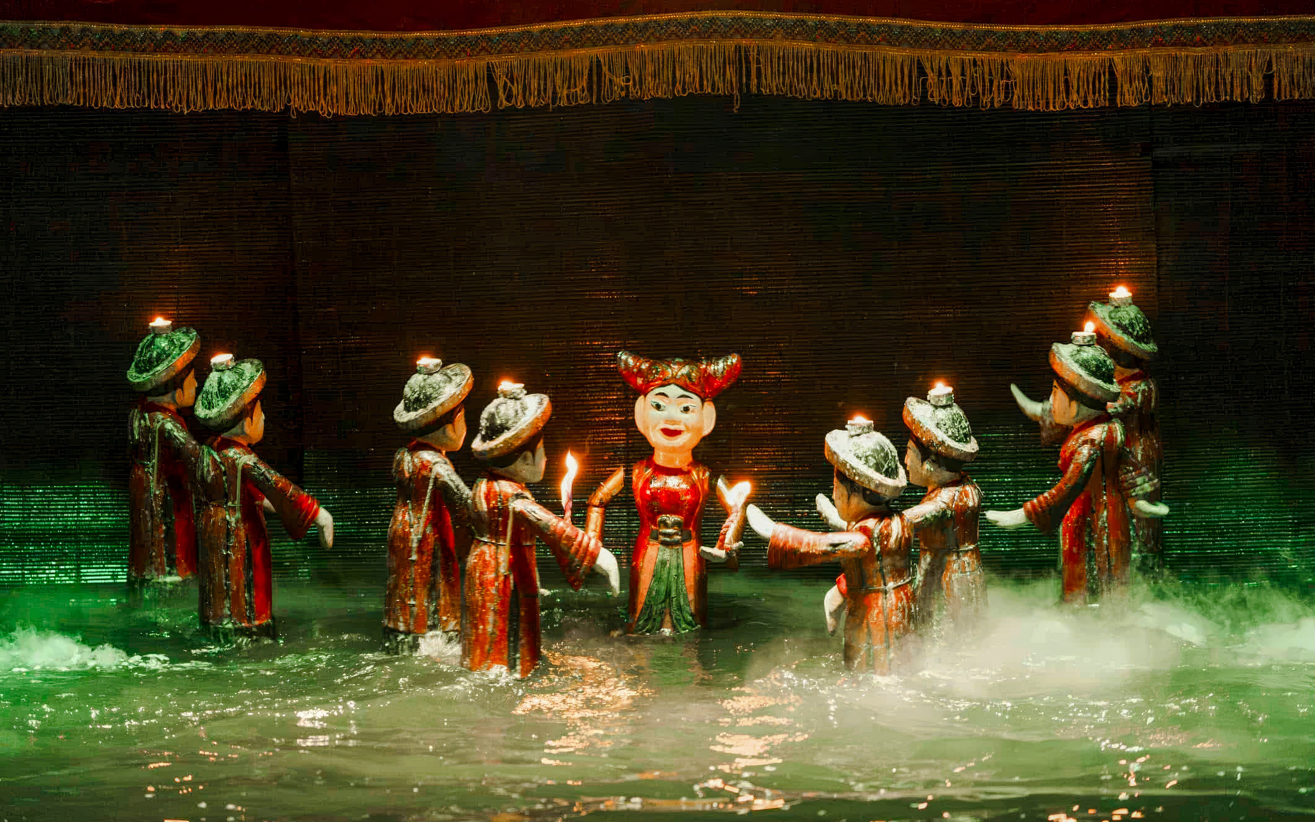 Thang Long Water Puppet Show with puppets performing on water stage in Hanoi, Vietnam.