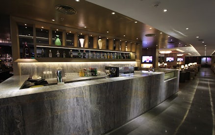 Bar area at Plaza Premium First lounge, Satellite Terminal, with drinks and seating.
