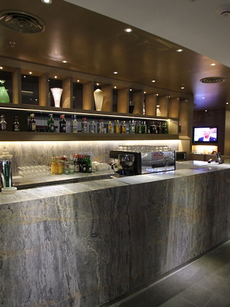 Bar area at Plaza Premium First lounge, Satellite Terminal, with drinks and seating.
