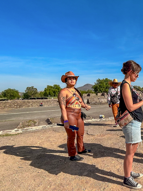 Tour group exploring Teotihuacan, Mexico with a guide explaining the site.