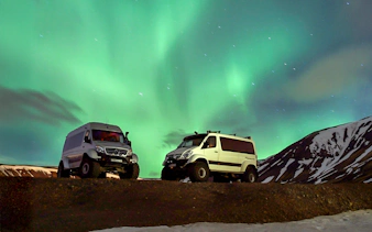 Premium jeeps under Northern Lights during Iceland tour.