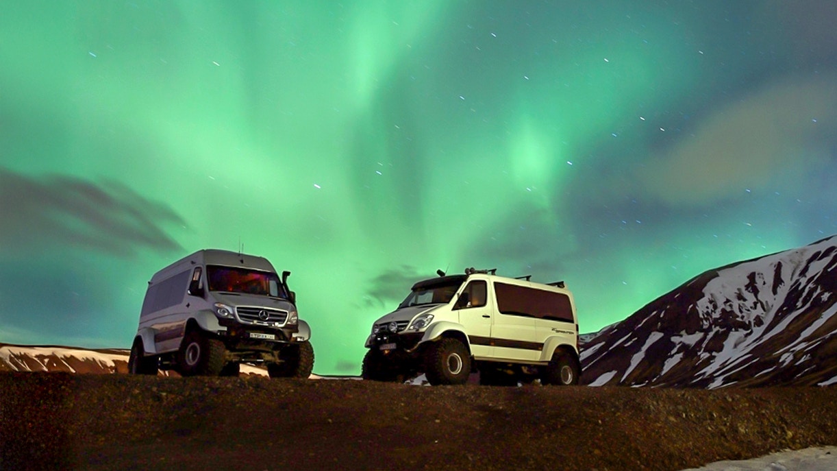Premium jeeps under Northern Lights during Iceland tour.