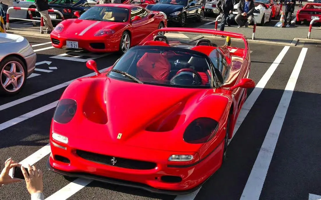 Red sports cars parked in Tokyo for the Drift 5.0 Fast & Furious experience.