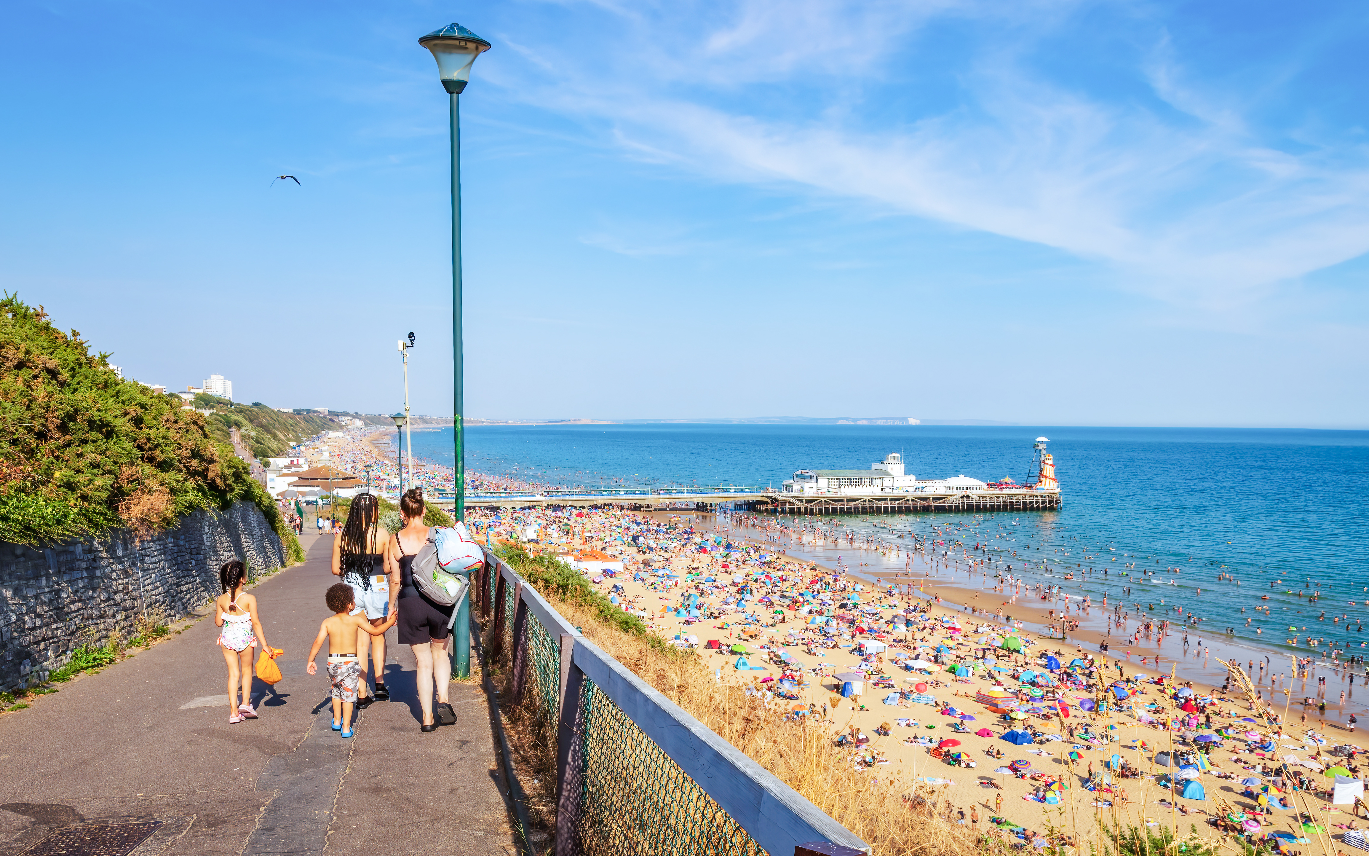 Woman with kids going towards Bournemouth Beach in Dorset