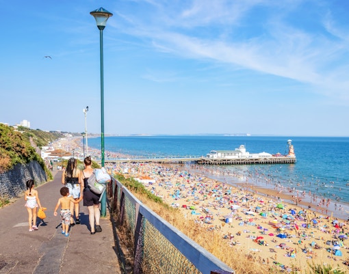 Woman with kids going towards Bournemouth Beach in Dorset
