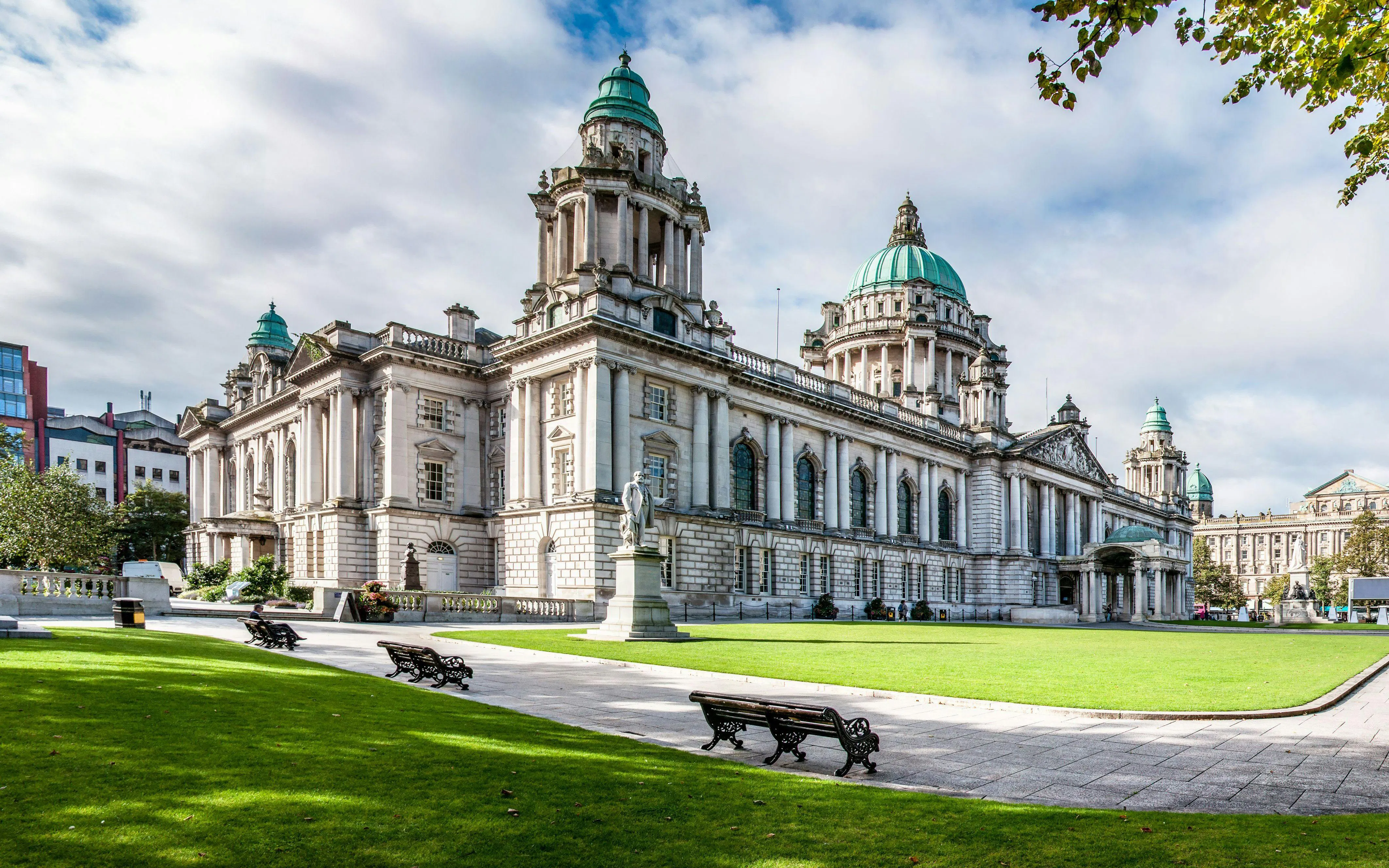 Belfast City Hall with its iconic green domes and surrounding gardens.