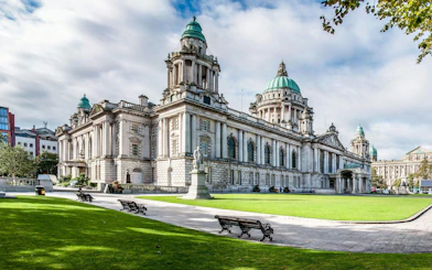 Belfast City Hall with its iconic green domes and surrounding gardens.