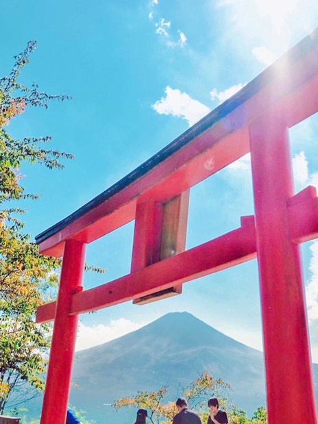 Red torii gate and rabbit statue with Mt. Fuji in the background.