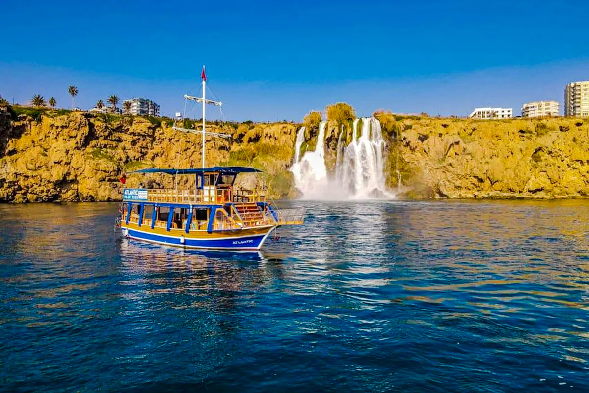 Boat near Duden Waterfall on a sunny day in Antalya.