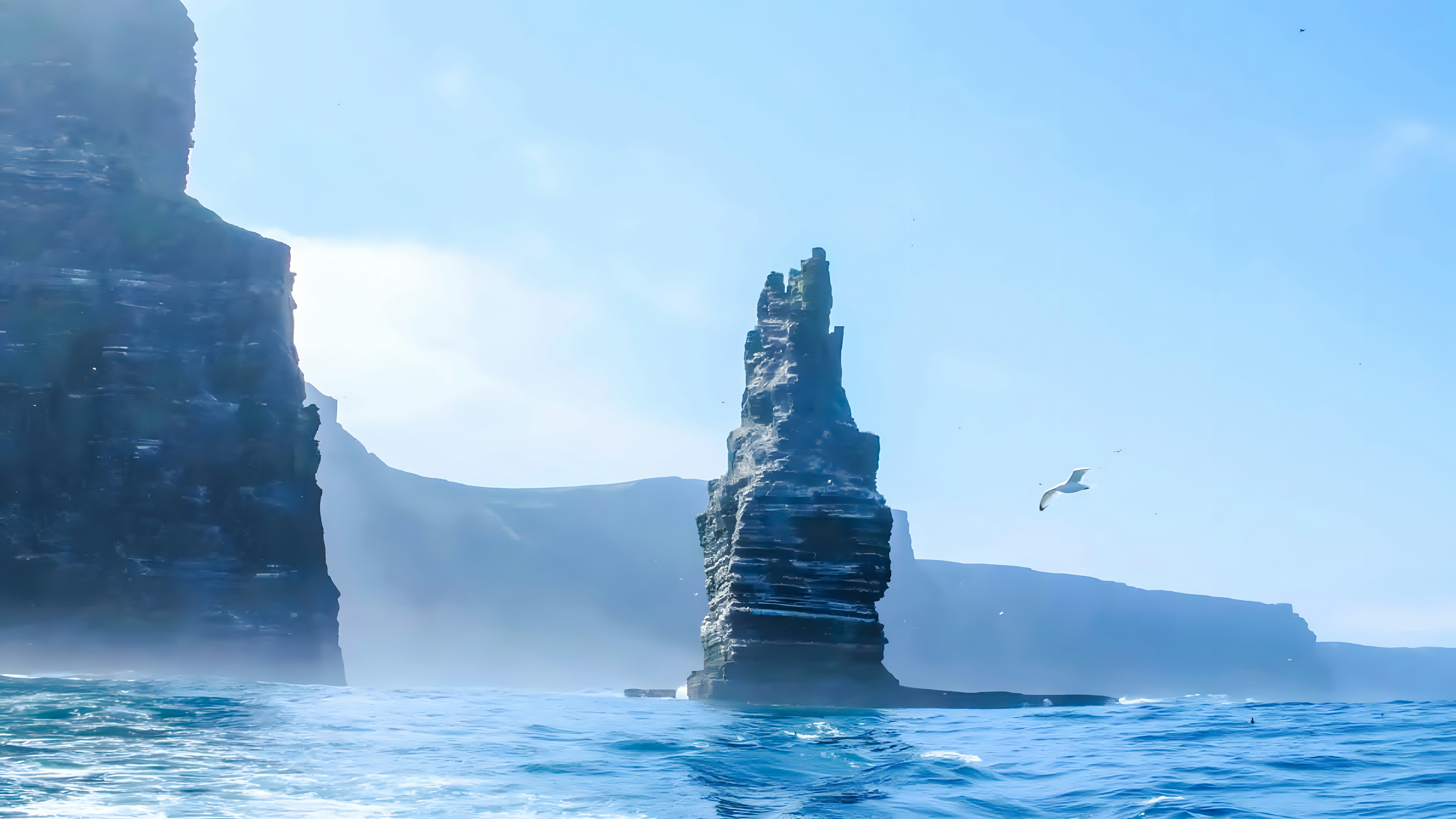 Cliffs of Moher sea stack with a seagull flying above the ocean in Ireland.