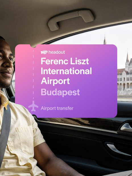 Private transfer passenger in car with Budapest Parliament view.