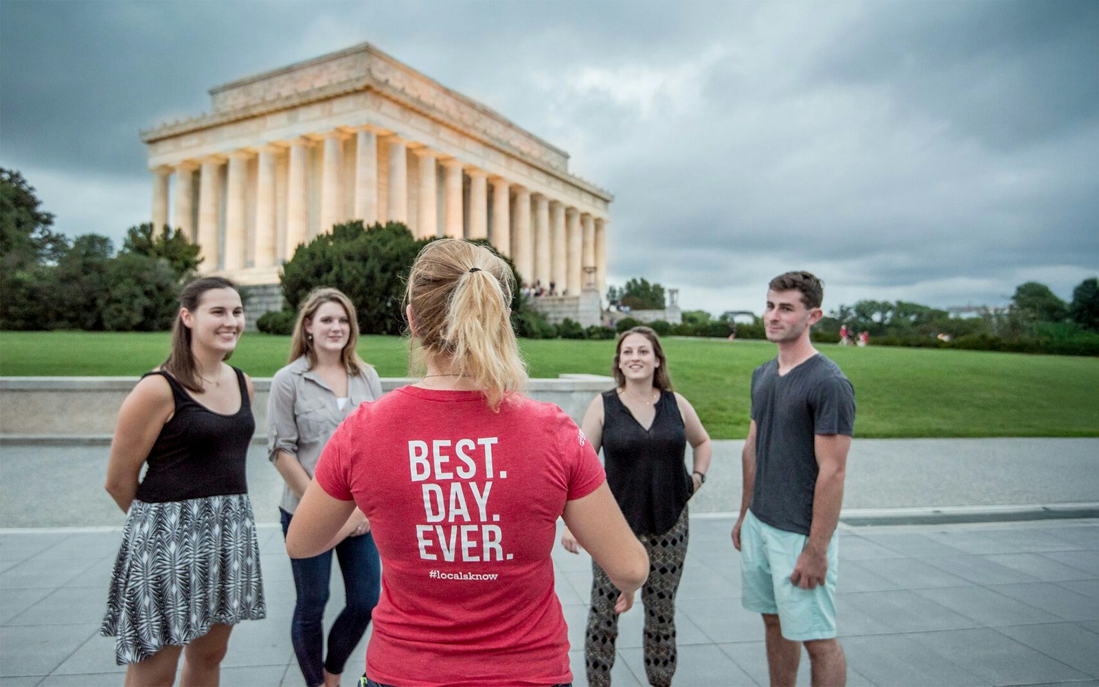 Tourists listening to a guide in front of the Lincoln Memorial at dawn, Washington D.C.