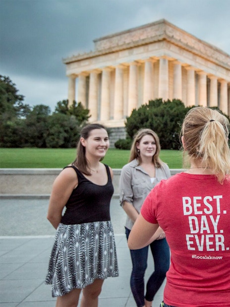Tourists listening to a guide in front of the Lincoln Memorial at dawn, Washington D.C.