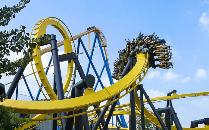 Roller coaster loop at Six Flags Great Adventure, BATMAN™ The Ride, with riders upside down.
