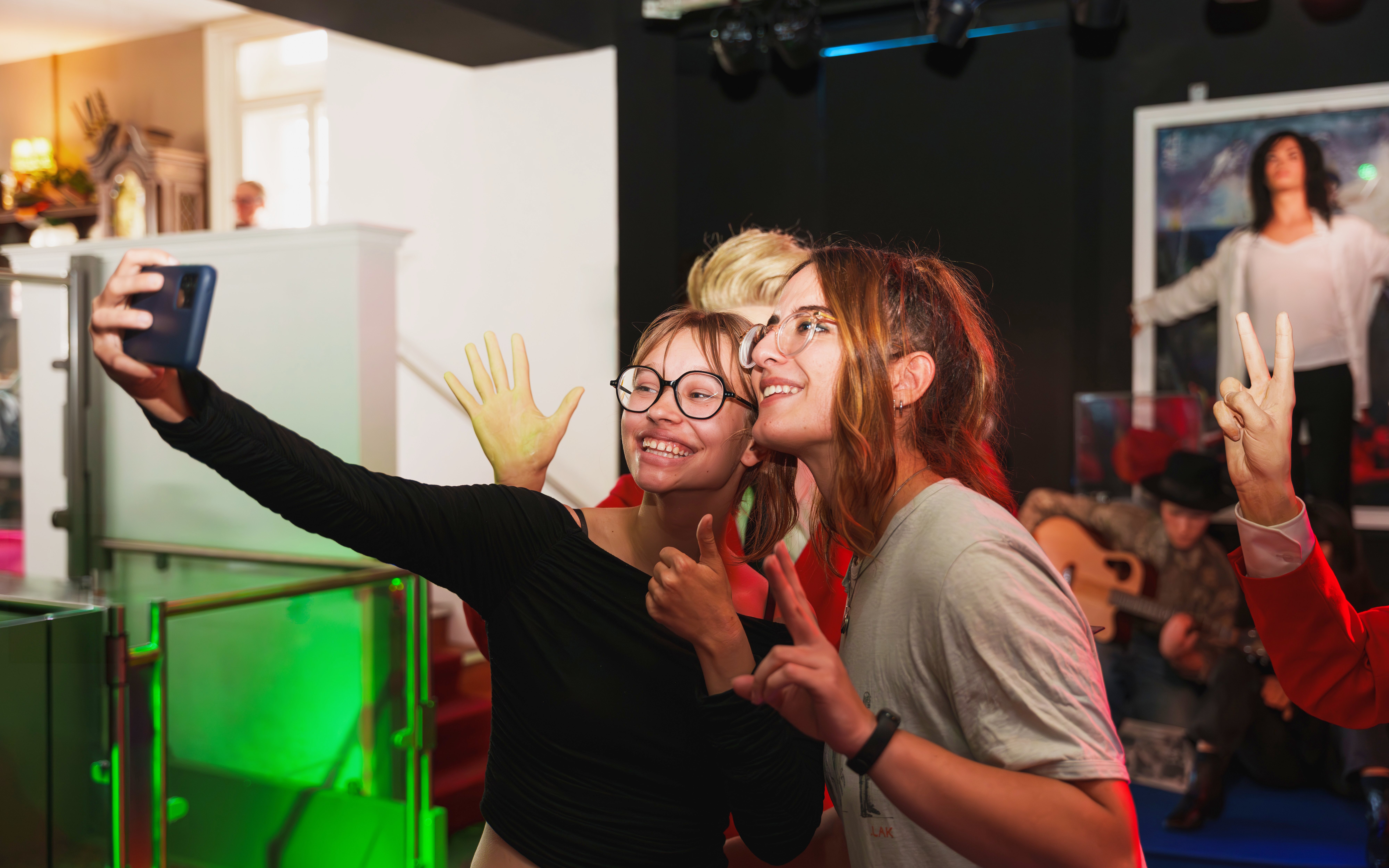 Visitors taking a selfie with wax figures at the National Wax Museum.