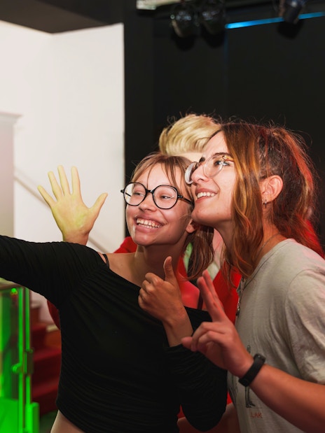 Visitors taking a selfie with wax figures at the National Wax Museum.