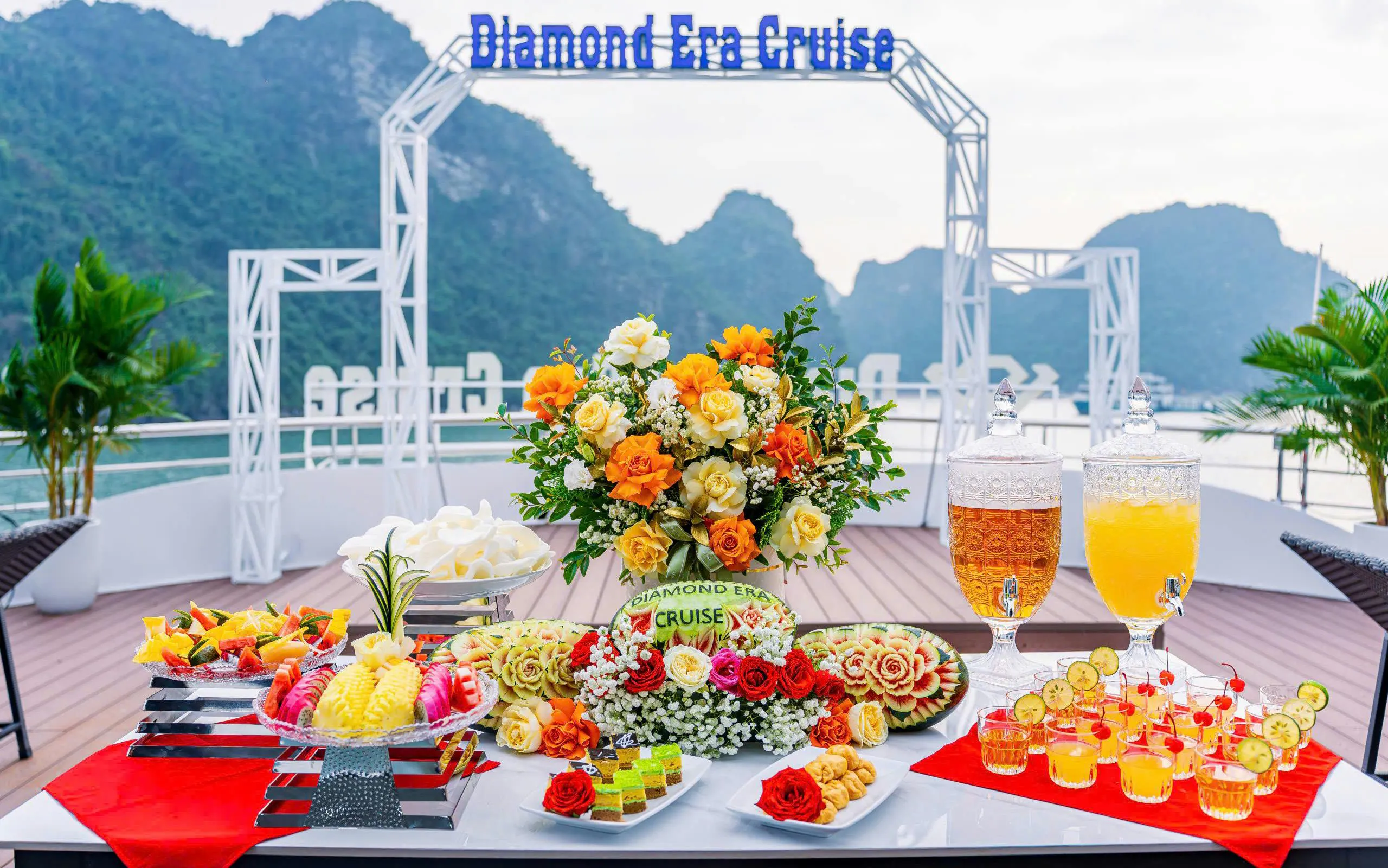 Luxury dining setup on Ha Long Bay's Diamond Era Cruise with floral centerpiece and refreshments.